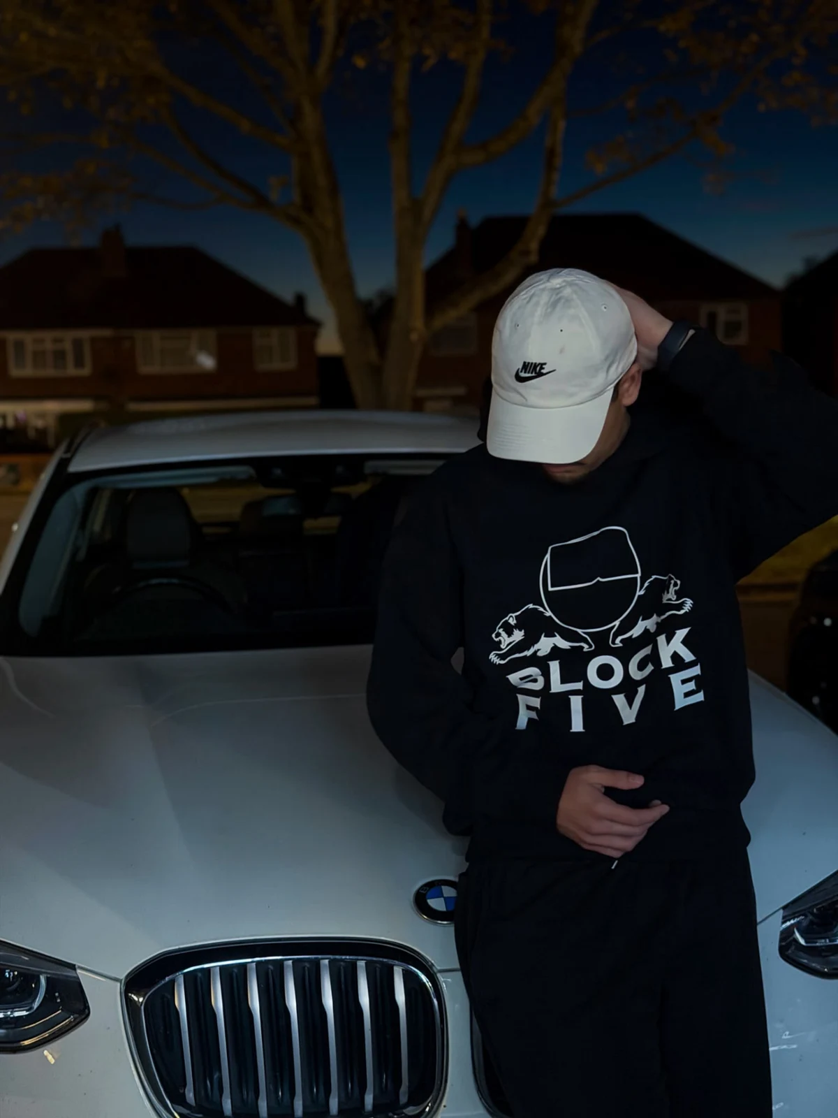 Black NO RUSH fit beside a silver car at night