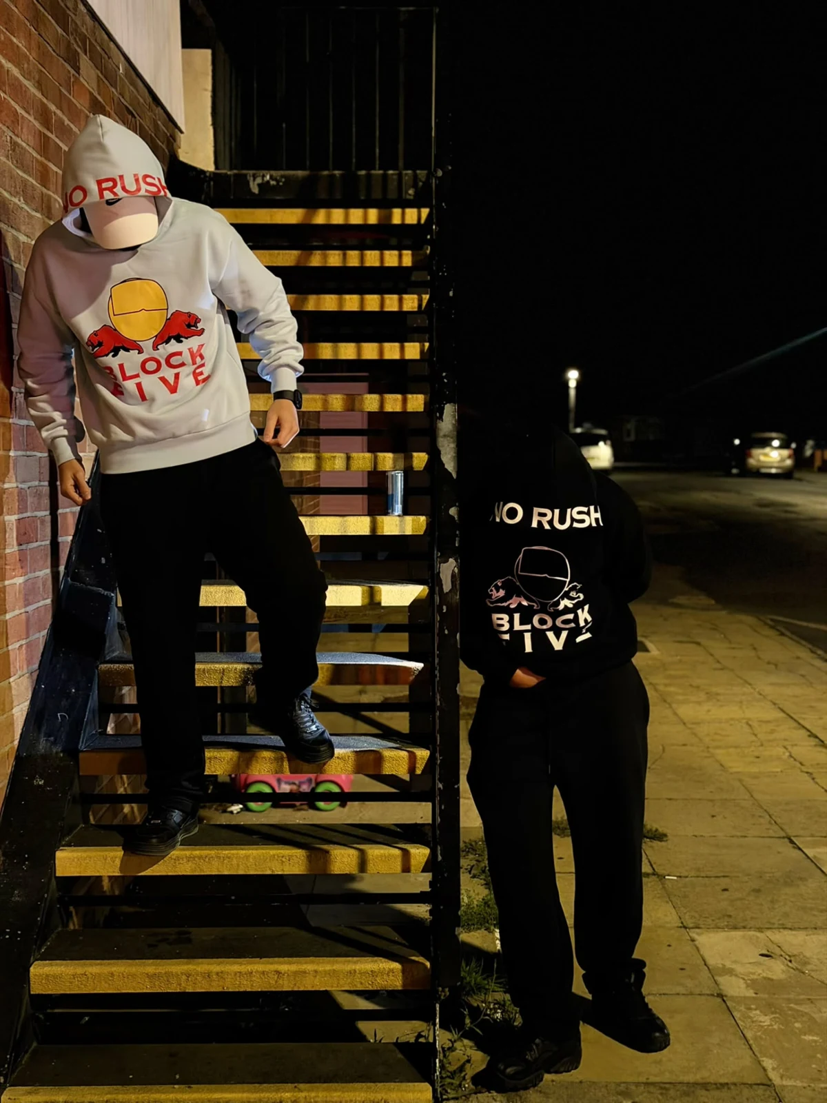 Two NO RUSH fits on an outdoor staircase at night
