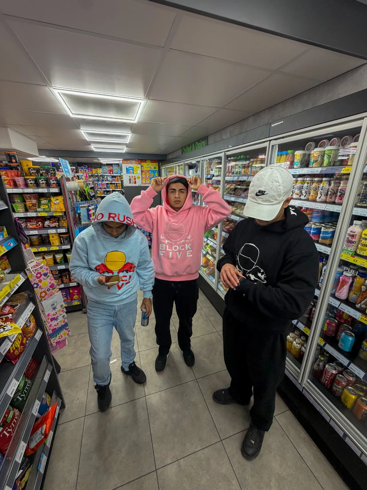 Three NO RUSH fits in blue, pink and black in a corner shop